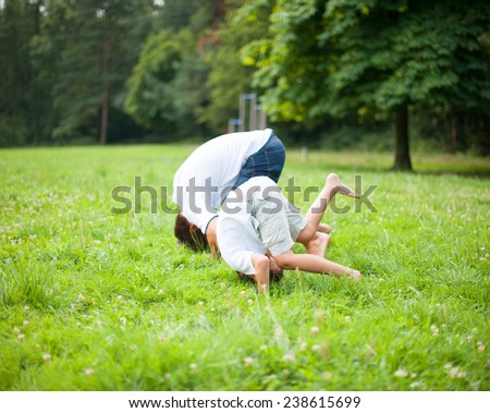 Father and son somersaulting on the ground Royalty-Free Stock Photo #238615699
