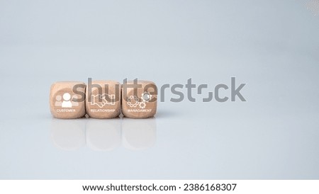 Wooden block printed icon of CRM concept representing business goal selection, target customers, marketing plan and strategy, customer centric strategy. Royalty-Free Stock Photo #2386168307