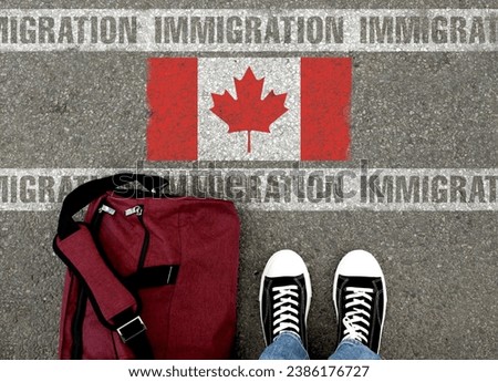Immigration. Man with bag standing on asphalt near flag of Canada, top view
