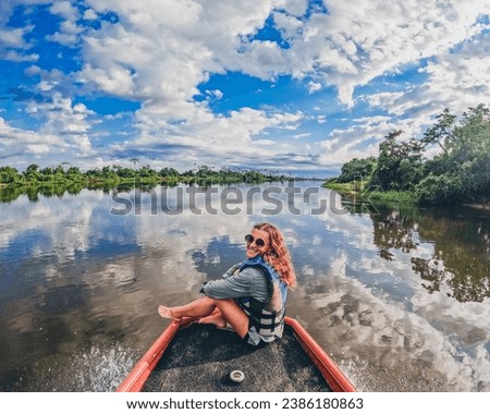 woman on a boat trip in the pantanal of Mato Grosso Royalty-Free Stock Photo #2386180863