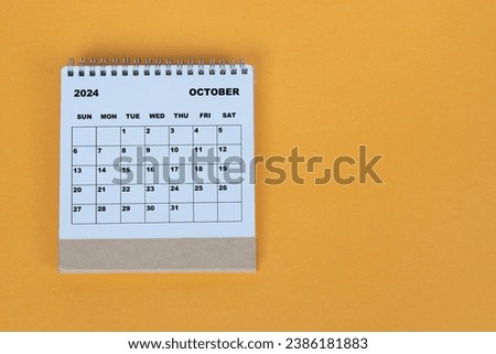 October 2024 desk calendar on yellow background. Directly above. Flat lay. Royalty-Free Stock Photo #2386181883