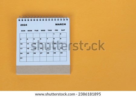 March 2024 desk calendar on yellow background. Directly above. Flat lay. Royalty-Free Stock Photo #2386181895