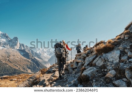 Group of hiker hiking on mountain trail with difficult to Lac Blanc amidst French alps on sunny day at France Royalty-Free Stock Photo #2386204691