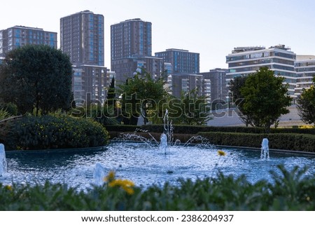 Urban view. A pond in the park and residential district on the background. Landscaping or real estate or mortgage concept photo.