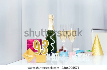 Date of birth with number  93. Festive Champagne in glasses with gift boxes, anniversary postcard. Happy birthday golden candles. Royalty-Free Stock Photo #2386205571