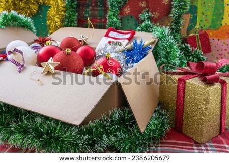 Cartoon box with Christmas decorations beside gift box