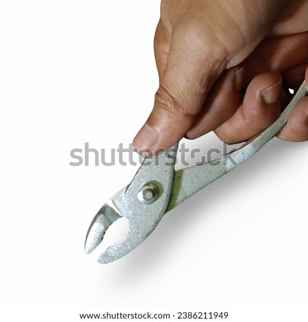 close-up of hand holding pliers on white background, repair tool 
