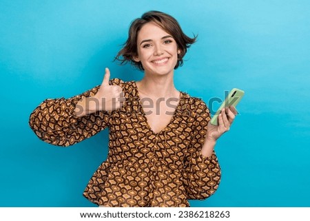 Photo of funny young lady thumb up sign wear glamour retro blouse feedback recommendation iphone speed isolated on blue color background