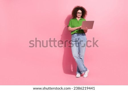 Full length photo of successful lovely girl wear trendy clothes write letter netbook device empty space isolated on pink color background