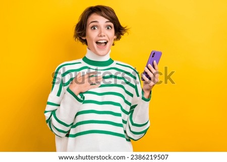 Photo of shocked impressed lady wear striped pullover communicating instagram twitter telegram facebook isolated yellow color background