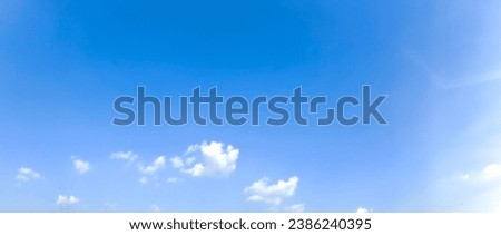 Clear Blue Sky background. Small clouds on clear blue sky in sunny day. Tiny clouds with deep blue sky. Nature concept background. Landscape photo