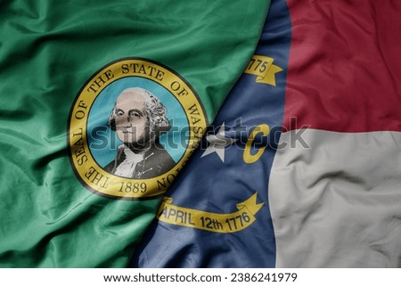 big waving colorful national flag of north carolina state and flag of washington state . macro