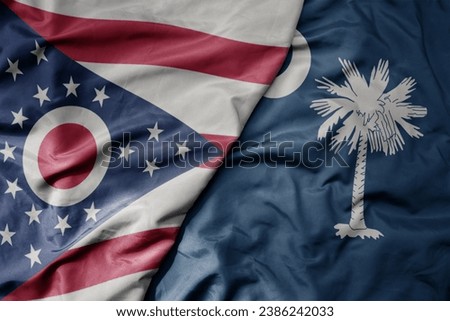 big waving colorful national flag of south carolina state and flag of ohio state . macro