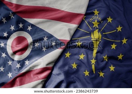 big waving colorful national flag of indiana state and flag of ohio state . macro
