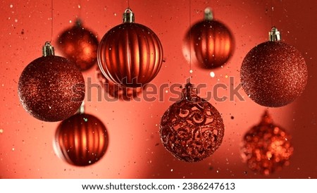 Decorative Christmas Balls Hanging with Glitters Falling Down. Abstract Celebration Background.