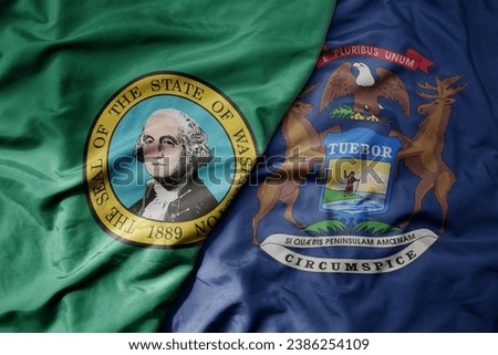 big waving colorful national flag of michigan state and flag of washington state . macro