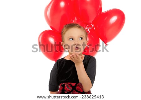 Cute little girl holding a bunch of red heart-shaped balloons 