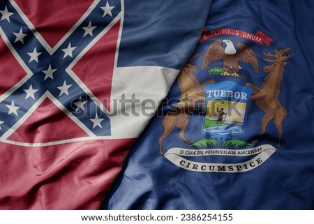 big waving colorful national flag of michigan state and flag of mississippi state . macro