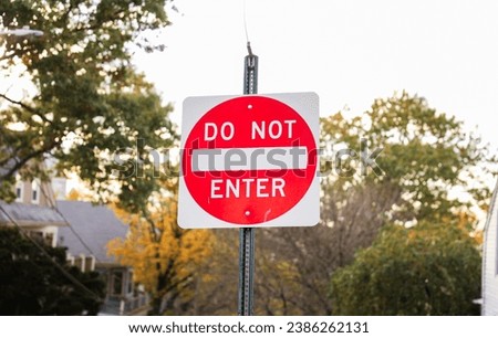 'Do Not Enter' sign against a clear blue sky, a powerful symbol of restriction and caution on the road