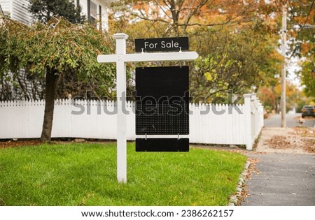 'For Sale' sign against a blue sky, symbolizing real estate opportunities with space for your dreams