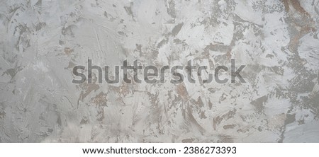 The texture of the plaster on the wall, rough strokes made with a palette knife, paint on the surface, abstract background for design Royalty-Free Stock Photo #2386273393