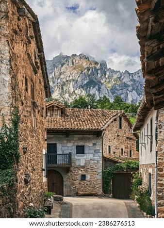 Backstreet in the medieval village of Mogrovejo with the European Peaks in the background.In Camaleño, Cantabria, Spain