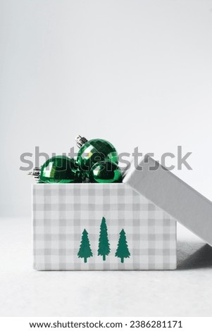 green Christmas ornaments in a gift box, Christmas gift box with sparkly green tree baubles, green Christmas tree decoration