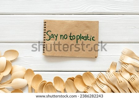 Eco friendly wooden cutlery with Say no to plastic sign. Zero waste concept.