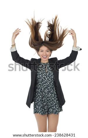 Young woman jumping in the air against a white background