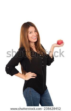 Healthy young woman holding a red apple against a white background