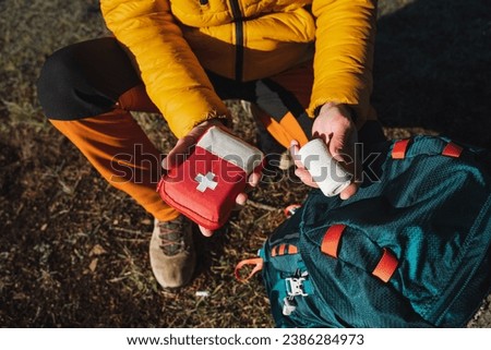 First aid kit in a critical situation in nature, camping equipment, survival in the forest. High quality photo