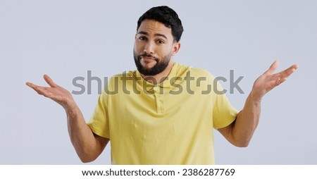 Man, hands and confused portrait in studio, question and unsure of options by white background. Idea, why and young person with doubt for decision, uncertain and shoulder shrugging by mockup space Royalty-Free Stock Photo #2386287769