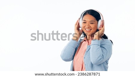 Headphones, happy or woman in listening to music, playlist or podcast for entertainment. Smile, asian female and relax to stream a song, online radio subscription and technology by white background