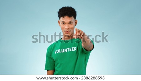 Portrait, man and pointing at you for volunteer in studio for climate change mockup on blue background in Cape Town. Young, male model and talking for support, decision and eco friendly for future