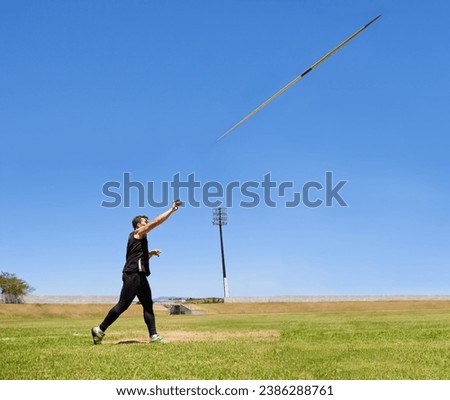 this is going the distance. Shot of a lone man throwing a javelin outside. Royalty-Free Stock Photo #2386288761