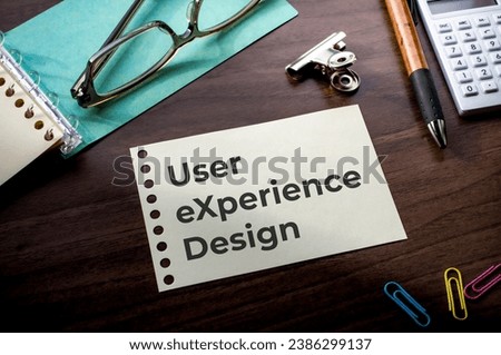 There is notebook with the word User eXperience Design. It is as an eye-catching image.