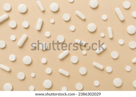 Flat lay with different medical pills and capsules on color background Royalty-Free Stock Photo #2386302029