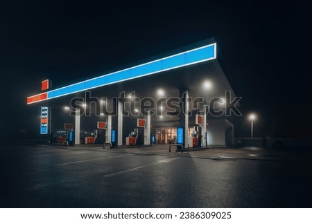 Gas station at foggy night. Royalty-Free Stock Photo #2386309025