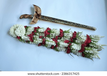 Kolong Keris is the flower for the groom's keris necklace. Made from 2 types of jasmine flowers that are still in bud and half blooming, kantil flowers, daisies and red roses. Royalty-Free Stock Photo #2386317425