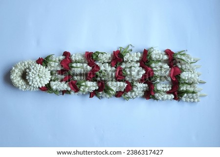 Kolong Keris is the flower for the groom's keris necklace. Made from 2 types of jasmine flowers that are still in bud and half blooming, kantil flowers, daisies and red roses. Royalty-Free Stock Photo #2386317427