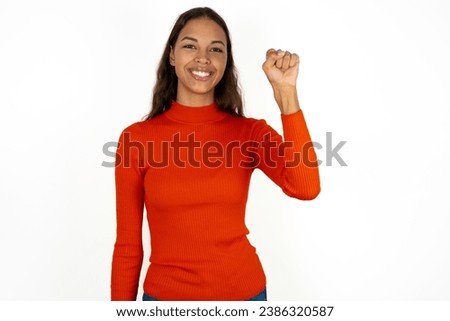 Young beautiful woman pointing up with fingers number ten in Chinese sign language Shi