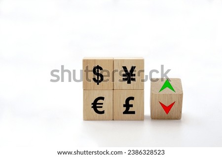 The exchange rate icon on wooden block cubes and arrows show lowering and increasing according to the index exchange rate.