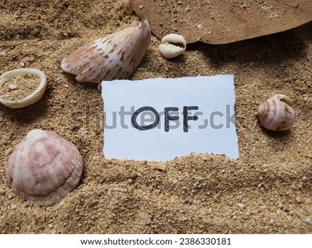 Off writing on beach background.