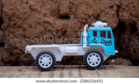 Blue and white construction truck toy in the yard