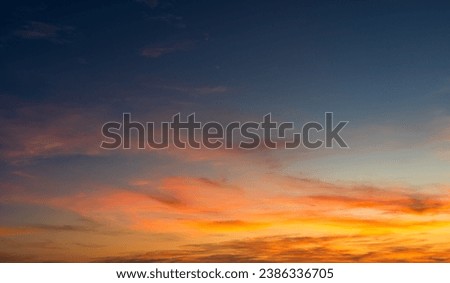 Sunset sky clouds with colorful orange sunlight in the evening, Beautiful Dramatic sky background , Dusk sky on twilight Royalty-Free Stock Photo #2386336705