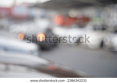 Defocus blurred background of car in parking lot. Blur outdoor car parking