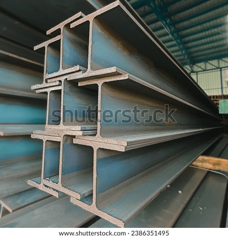 Steel beams production. Metal girders stack on project construction , steel h-beam, selective focus, Raw materials used in building construction.