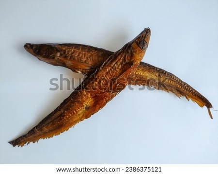 Smoked Asian Glass Catfish Isolated in the White Background Royalty-Free Stock Photo #2386375121