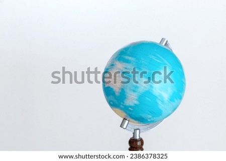 Rotating blue globe on white background