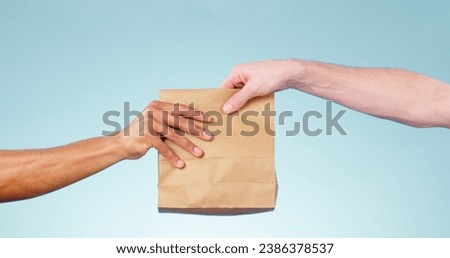 Hands, paper bag and delivery in studio closeup for fast food, supply chain and cargo by blue background. Courier, logistics and package for service, shipping and giving to customer for e commerce